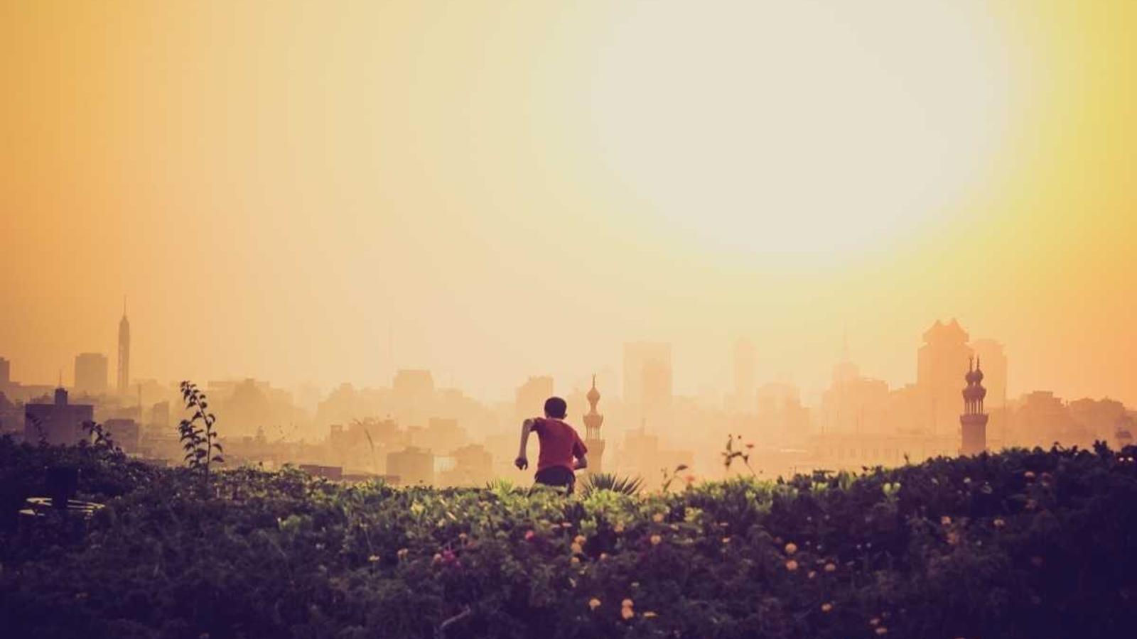 Grayscale minimalist desk layout with a single bright blue pen as the focal point.